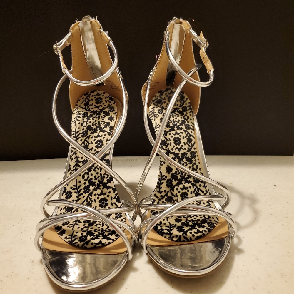 Silver heeled sandles. Size 8.5 strappy with a zipper up the back.